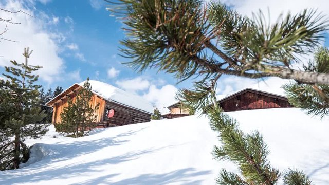 4k timelapse of clouds over a mountain hut in the Swiss Alps during the winter. 