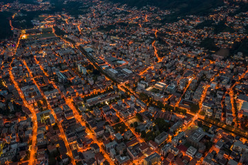 High angle aerial drone night shot of city street lights in Lugano, Switzerland
