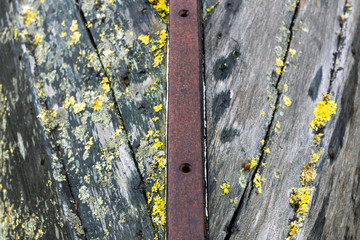 Wood and metal hull of a rotten and stranded boat wreck on land. Texture and rustic pattern concept...