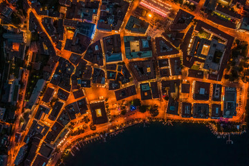 Overhead aerial drone night shot of city street lights in Lugano, Switzerland
