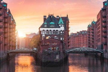 Hamburg city old port, Germany, Europe. Historical famous warehouse district with water castle palace at sunset golden light