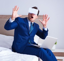 Businessman wearing a virtual reality headset in the bedroom