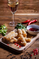 Breaded mozzarella cheese sticks with tomato sauce and white wine
