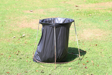 Black plastic garbage bags in the park