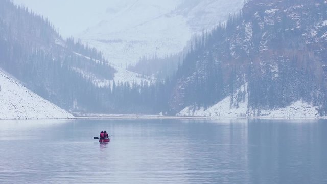 People canoeing Lake Louise and Mountains in the winter near Banff Alberta, Canada.  11 October 2019