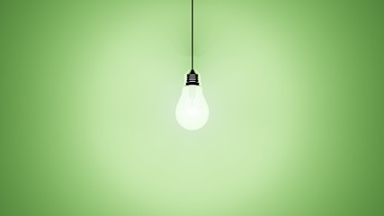 Singular hanging light bulb on green background