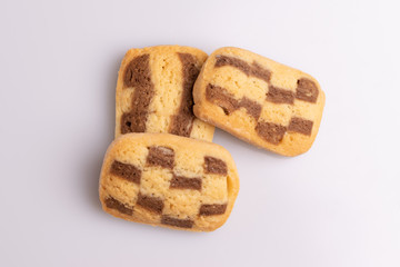 Home made cookies with chocolate, butter and vanilla, isolated on white background, soft light, angle view, copy space