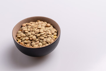 Dry uncooked lentils isolated on white background, copy space, studio shot, soft light. Christmas and New Year dish