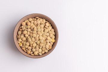 Dry uncooked lentils isolated on white background, copy space, studio shot, soft light. Christmas and New Year dish