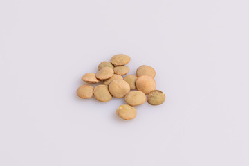 Dry uncooked lentils isolated on white background, copy space, studio shot, soft light. Christmas and New Year dish