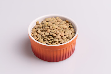 Dry uncooked lentils isolated on white background, copy space, studio shot, soft light. Christmas and New Year dish