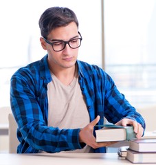 Student studying in the empty library with book preparing for ex