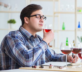 Professional sommelier tasting red wine