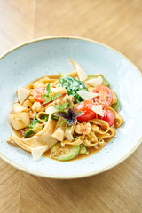 Italian pasta tagliatelle with seafood and tomato sauce. Pasta Gamberini. Parmesan cheese