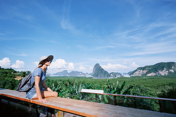 Traveling by Thailand. Young tourist woman enjoying wonderful view of Phang Nga bay with rock islands.