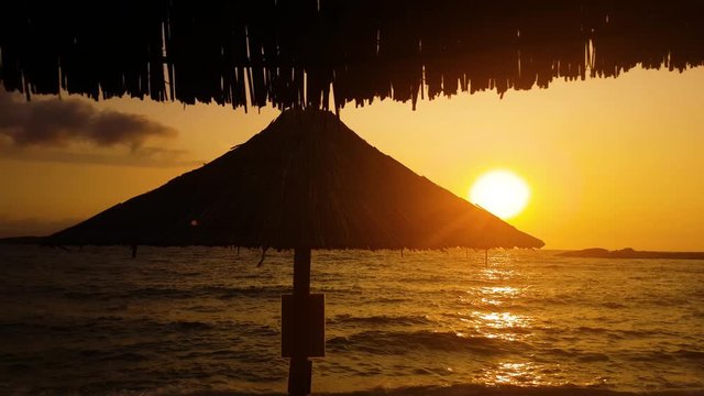 Amazing Greek ocean golden sunset idyllic paradise coast with leaf parasol