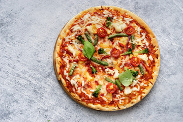 Homemade vegetarian pizza on light blue background