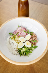 Soup okroshka. Traditional Russian summer cold dish with kvass in bowl on wooden background. Restaurant menu