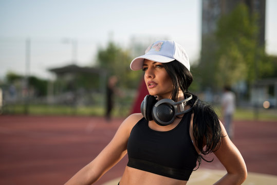 Closeup shot of beautiful female athlete with headphones 