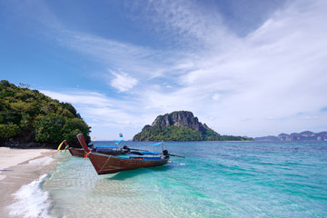 Plakat Beautiful landscape with traditional longtail boats, rocks, cliffs, tropical white sand beach. Traveling by Thailand.