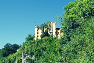 Fototapeta na wymiar View of Lugwig II Castle Hohenschwangau in Germany, on side of cliff