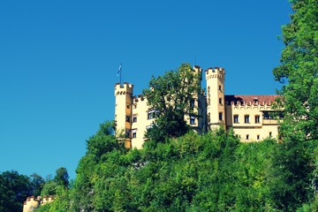 Fototapeta na wymiar View of Lugwig II Castle Hohenschwangau in Germany, on side of cliff