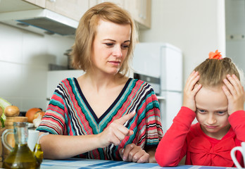 Upset mother shaming daughter