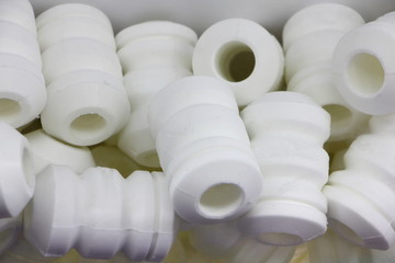 A many new white polyurethane buffers bumps for car shock adsorber, vehicle suspension repair - obrazy, fototapety, plakaty