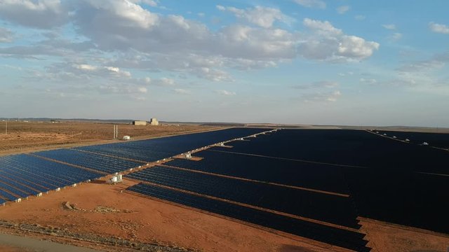 Drone view over a giant solar energy farm