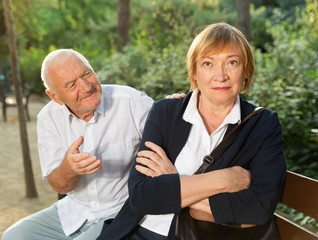 Senior woman sitting turned away