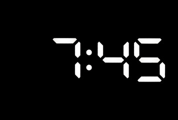 Real white led digital clock on black background