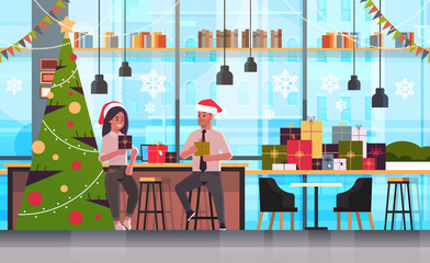 businesspeople couple giving present gift boxes to each other merry christmas happy new year holidays celebration concept modern office interior flat full length horizontal vector illustration