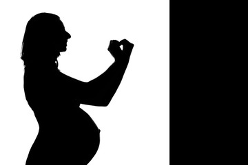silhouette of a pregnant woman on a white background. The expectant mother shows the heart sign with her hands. The concept of a healthy lifestyle, IVF, expression of emotions, gestures. Copy space