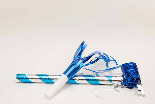 Isolated blue party blowers on white background