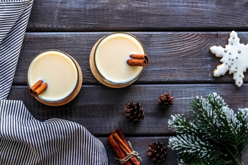Eggnog - cute New Year composition with alcoholic drink on dark wooden background top view copy space