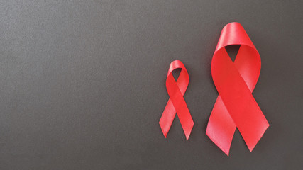 red ribbons on black background, hiv awareness concept, world AIDS day, world hypertension day