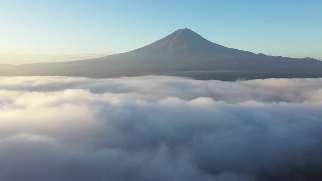 The Iconic Volcano Mount Fuji Revealed Above the Clouds with perfect Sunrise Light