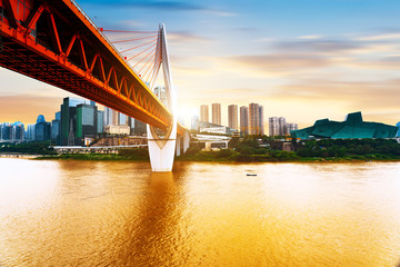 cityscape and skyline of downtown near water of chongqing at sunset