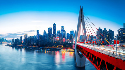 cityscape and skyline of downtown near water of chongqing at sunset