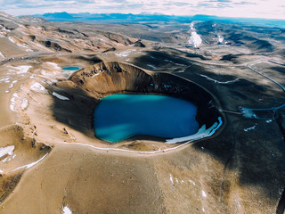Aerial view of Krafla caldera in the summer with turquoise water in it