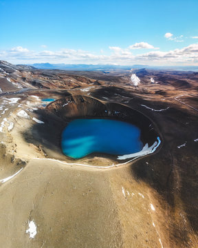 Aerial view of Krafla caldera in the summer with turquoise water in it