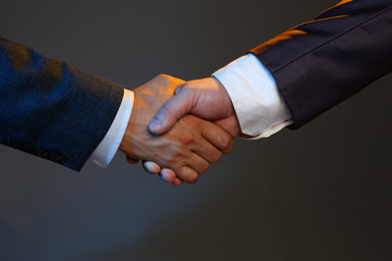Man in suit shake hand as hello in office closeup