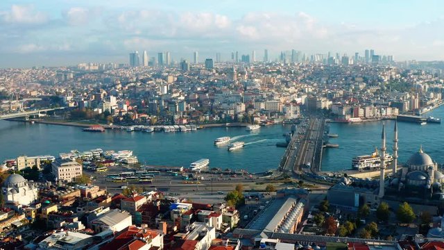 Aerial view of the Galata Bridge and the Golden Horn,  Istanbul, Turkey. Early morning drone footage panning left to right.