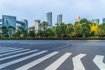 empty road with zebra crossing and skyscrapers in modern city.