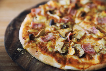 pizza ham and mushroom on wood background