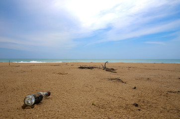 Fototapeta na wymiar Glass bottles Garbage on the dirty beach