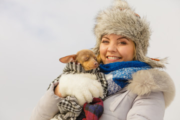 Fototapeta premium Woman hug warming her dog in cold day