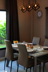 dish ware sets arrange on dining table inside eating room of modern home interior