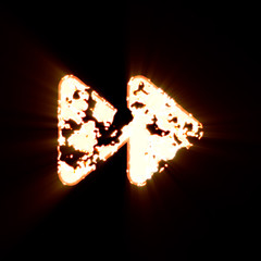 Symbol forward burned on a black background. Bright shine
