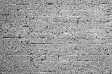 Surface of a worn out white brick wall